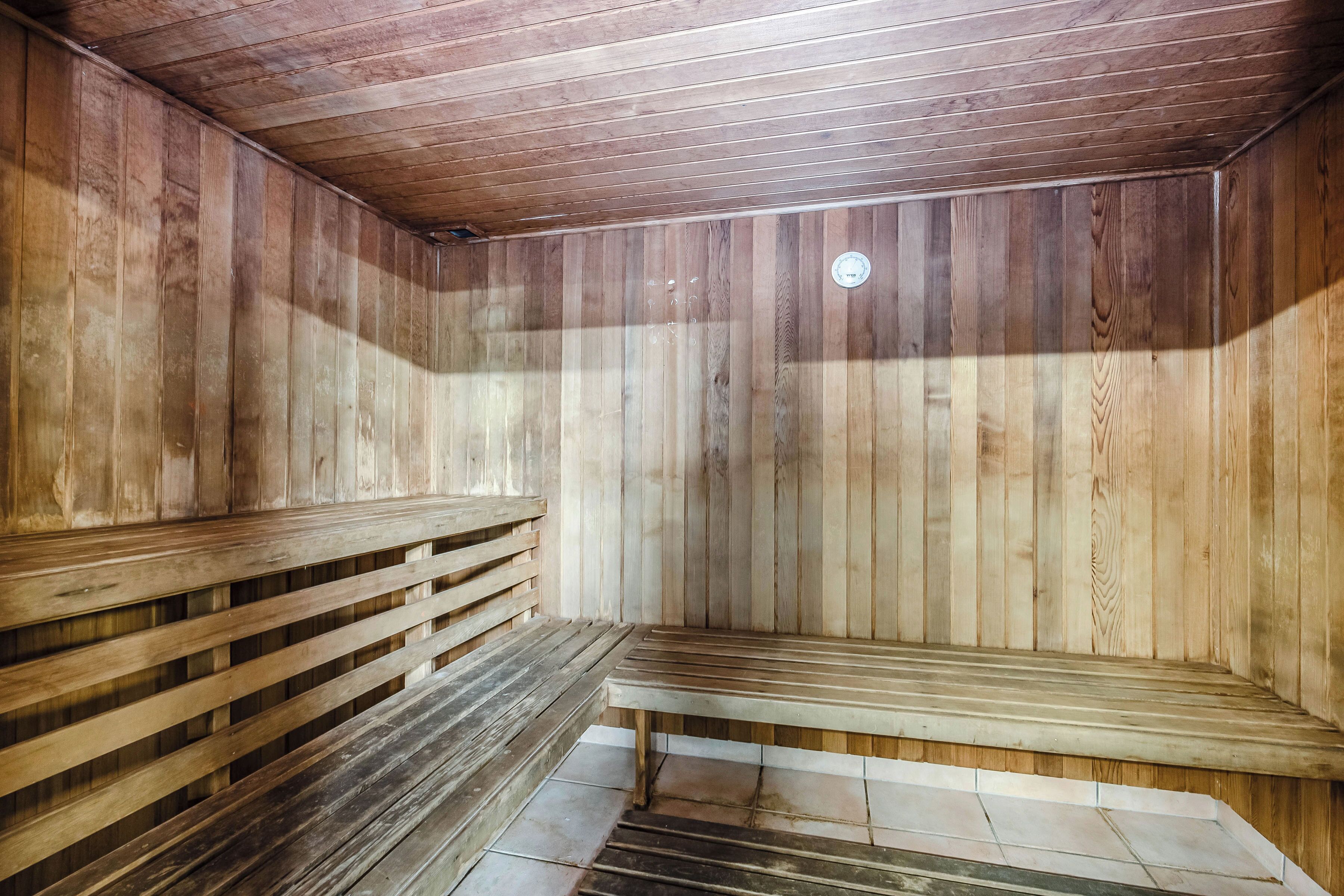 A sauna with wooden walls and benches.