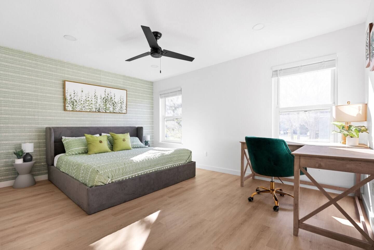 A bedroom with a bed, a desk, and a chair.
