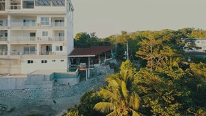 A multi-story building with balconies and a pool area. - Tablas Seaview Homestay (Ferrol)