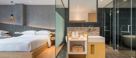 Ein modernes Hotelzimmer mit Bett, Schminktisch mit Spiegel und Duschbereich.