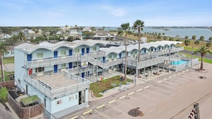 A motel with multiple units, a swimming pool, and a view of the ocean. - First level• Pool* Beach, Festival Grounds+ (Rockport)