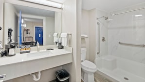 A modern bathroom with a large mirror, a sink, a toilet, and a walk-in shower. - 2nd level pool front • Kitchen • Walk to Beach (Rockport)