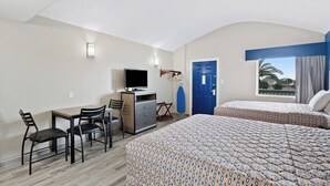 A hotel room with a desk, two beds, a TV, and a window with a view. - Waterview Penthouse, pool, stroll to marina, beach (Rockport)