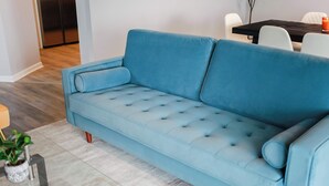 A light blue sofa with a tufted design in a modern living room.