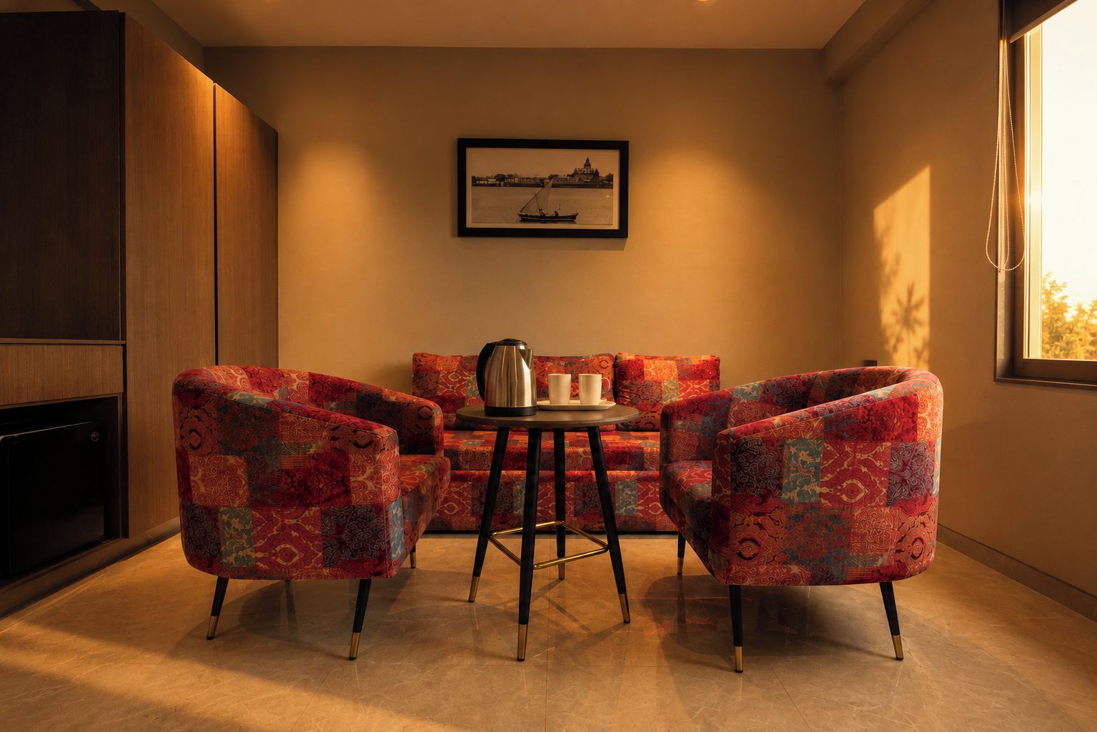 A cozy room with a sofa set, a small table with a kettle and cups, and a framed picture on the wall.