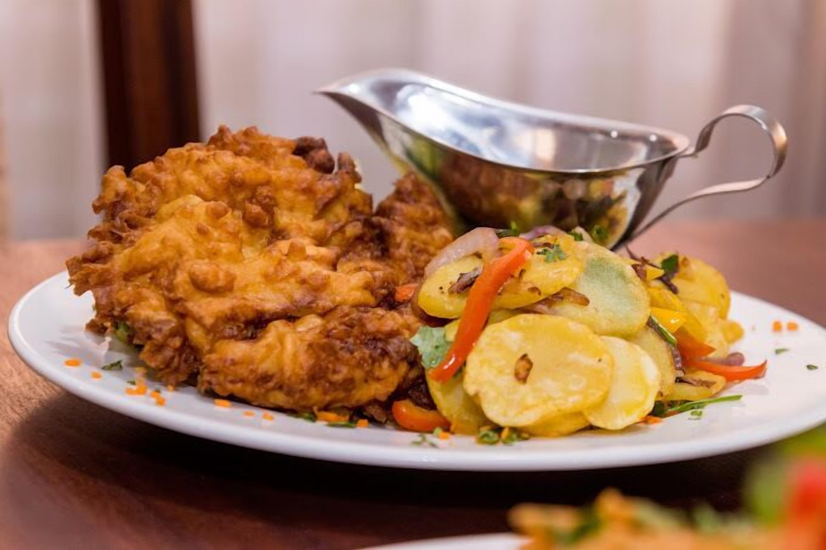 A plate with fried chicken and a side salad.
