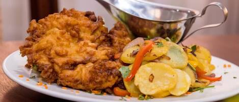 A plate with fried chicken and a side salad.