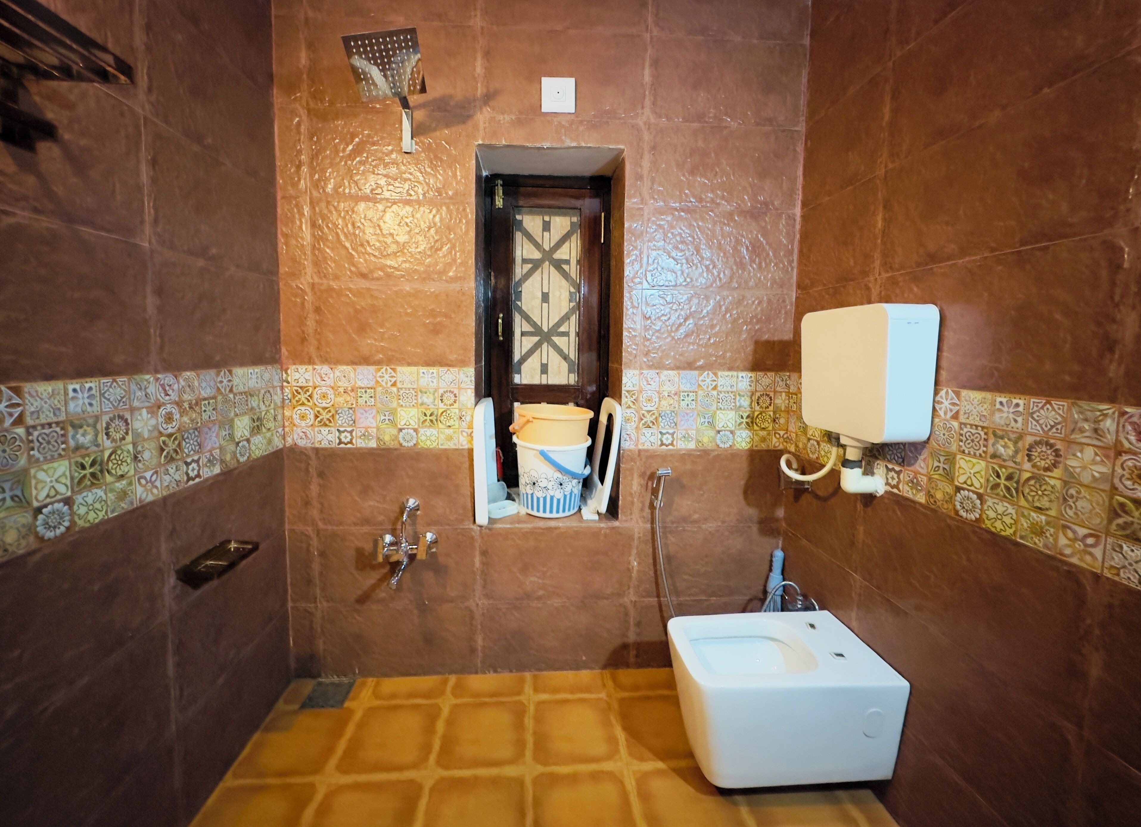 A bathroom with a shower, a toilet, and a sink.