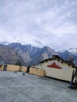 A rooftop with a view of snow-capped mountains.