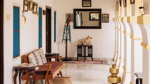 A spacious hallway with a wooden bench, a small table, and a decorative lamp. - Rawla Bisalpur (Bali)