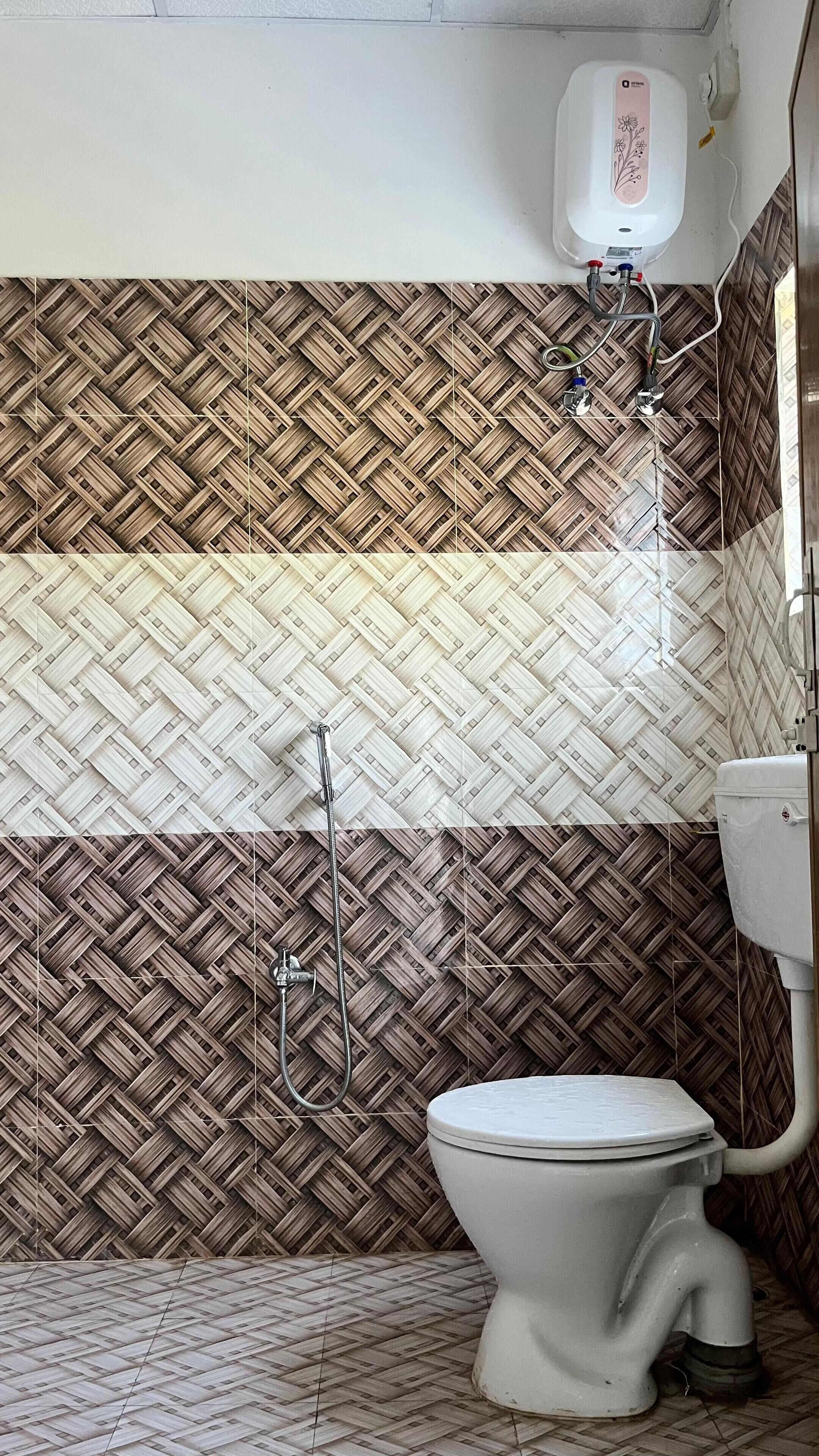 Een badkamer met een toilet, handdroger en douche.