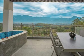 A balcony with a pool, a table, and chairs, overlooking a mountainous landscape. - GANGZHOU BENZYOO B&B Baishuizhai (Guangzhou)