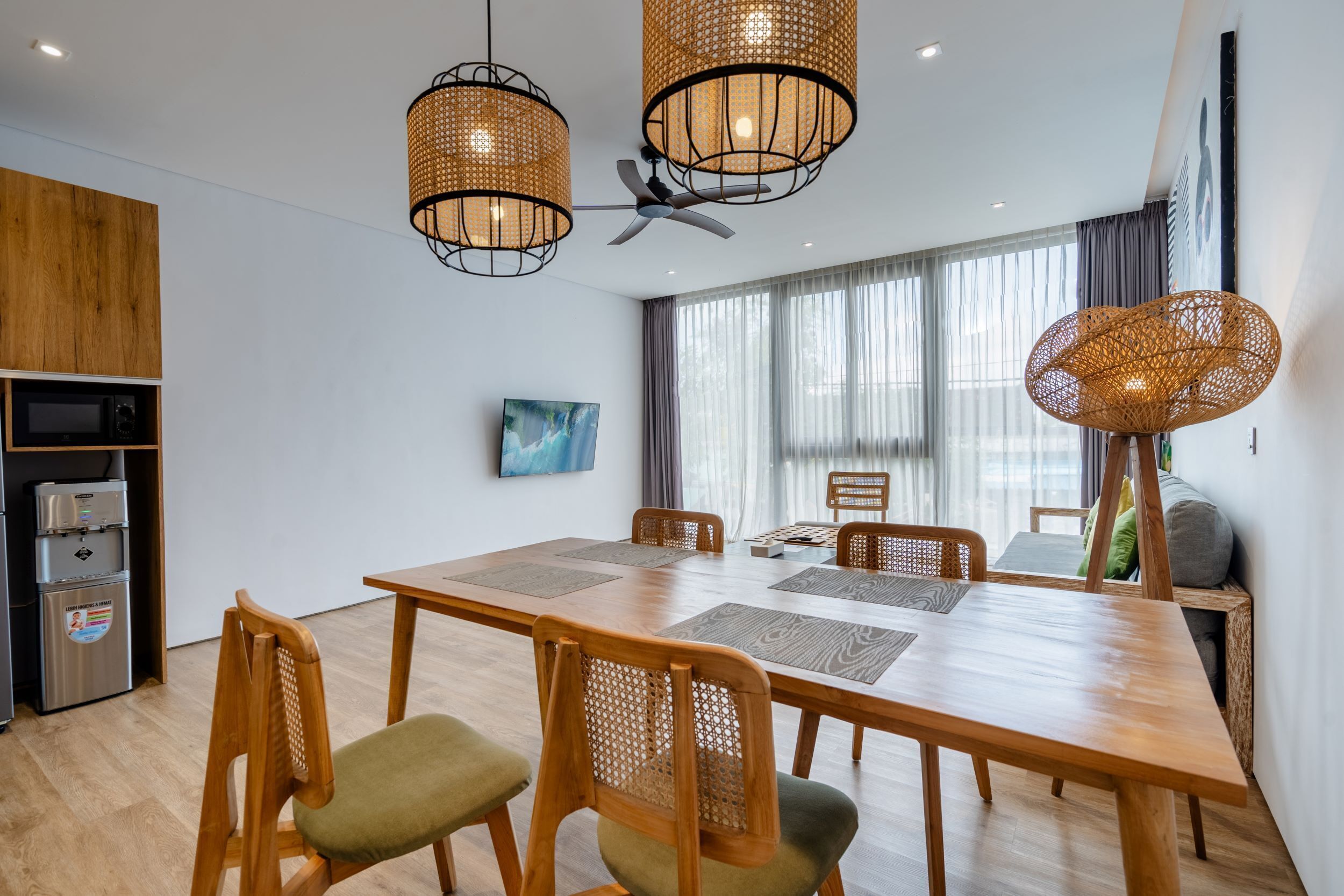 A modern dining area with a wooden table, chairs, and a ceiling fan.