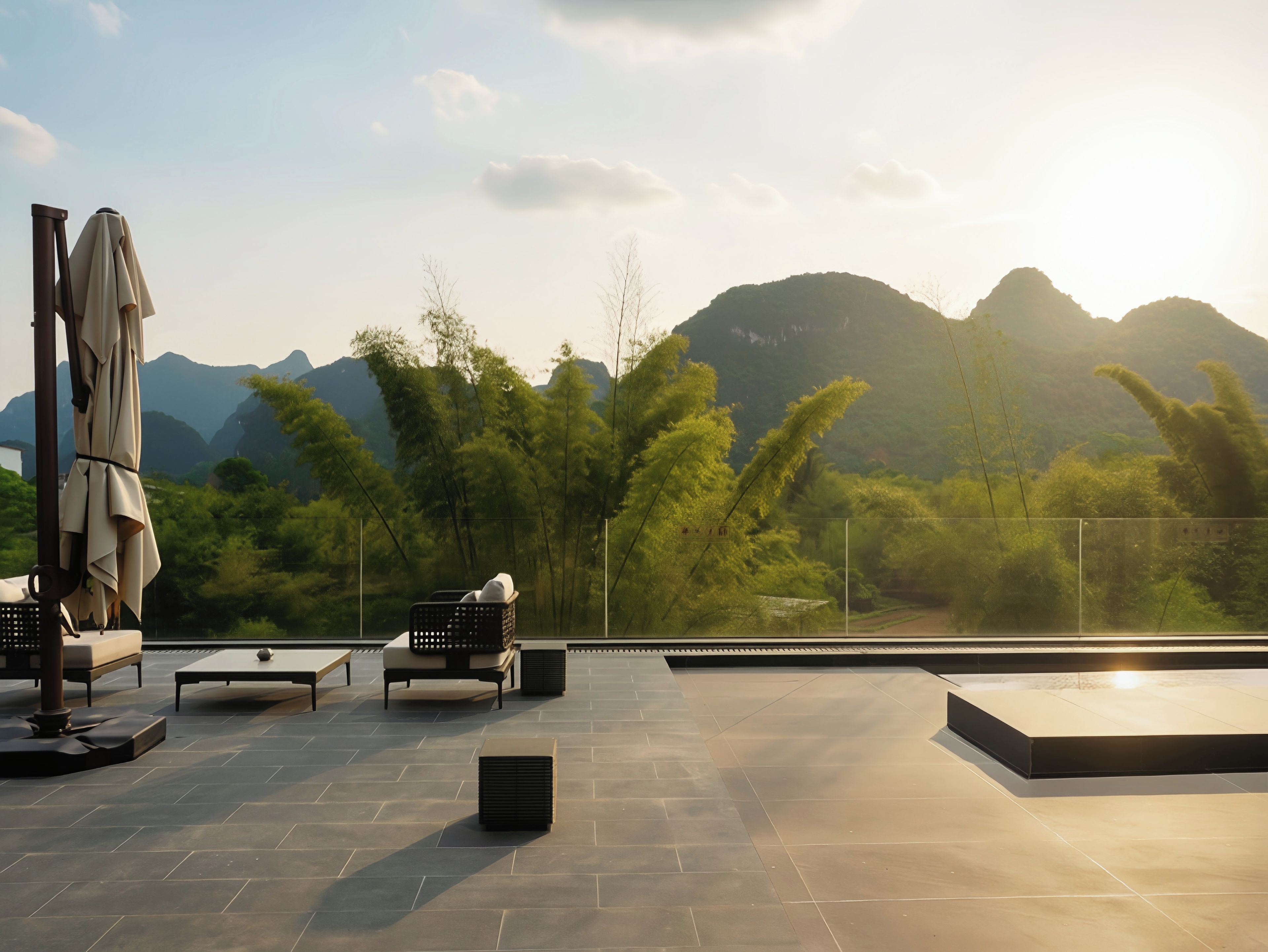 An outdoor terrace with seating, a table, and a view of mountains.