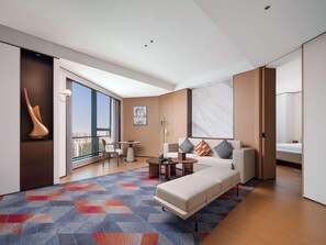 A modern living room with a sofa, coffee table, and a large window. - Pullman Chongqing Xiyue (Chongqing)