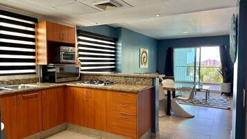 Fridge, microwave, stovetop, coffee/tea maker