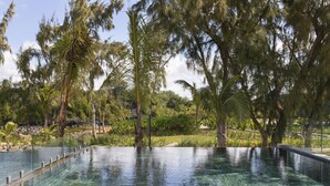 A clear swimming pool surrounded by trees and greenery. - Ocean Grand Gaube (Grand Gaube)
