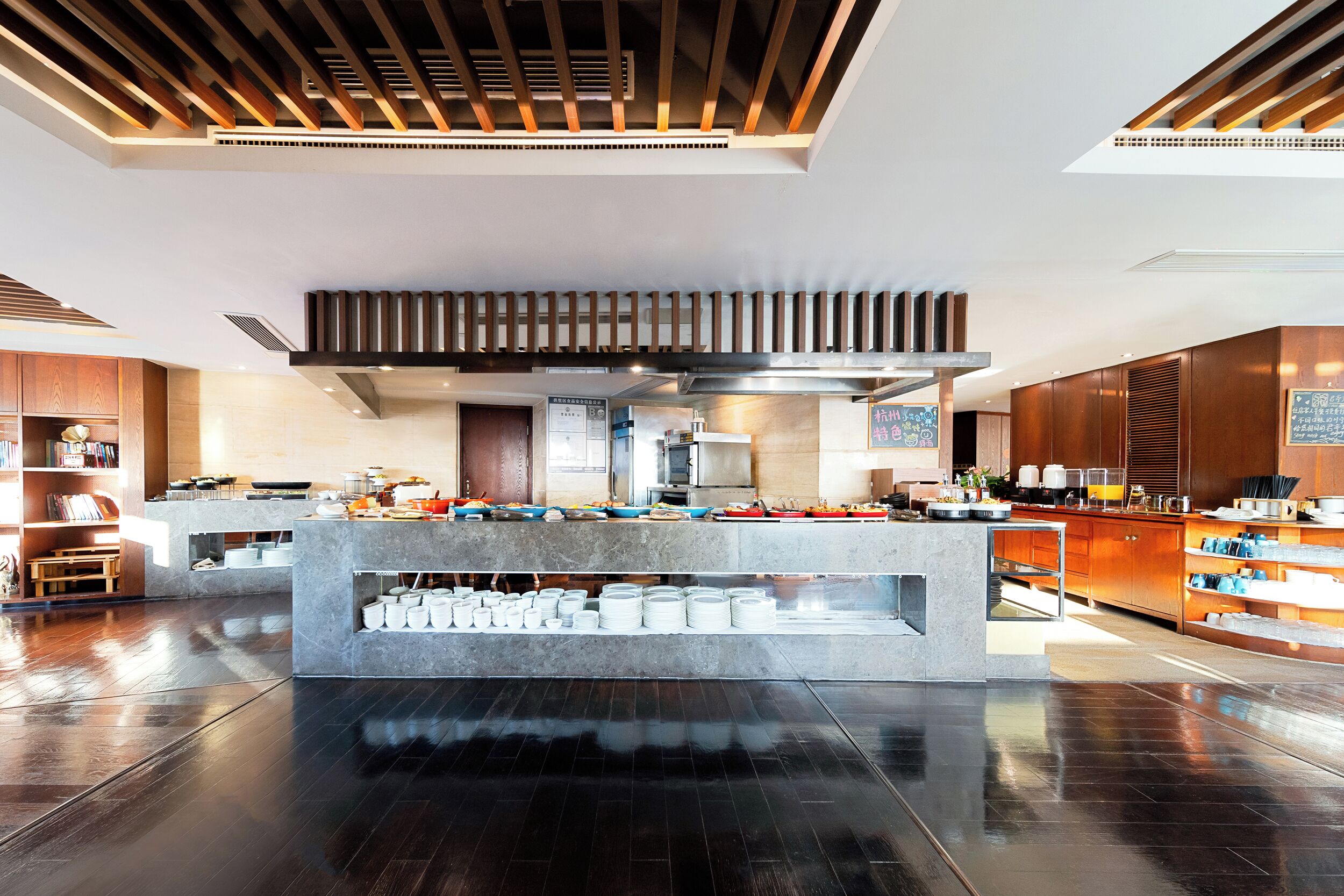 A modern kitchen with a central island, stainless steel appliances, and wooden cabinetry.