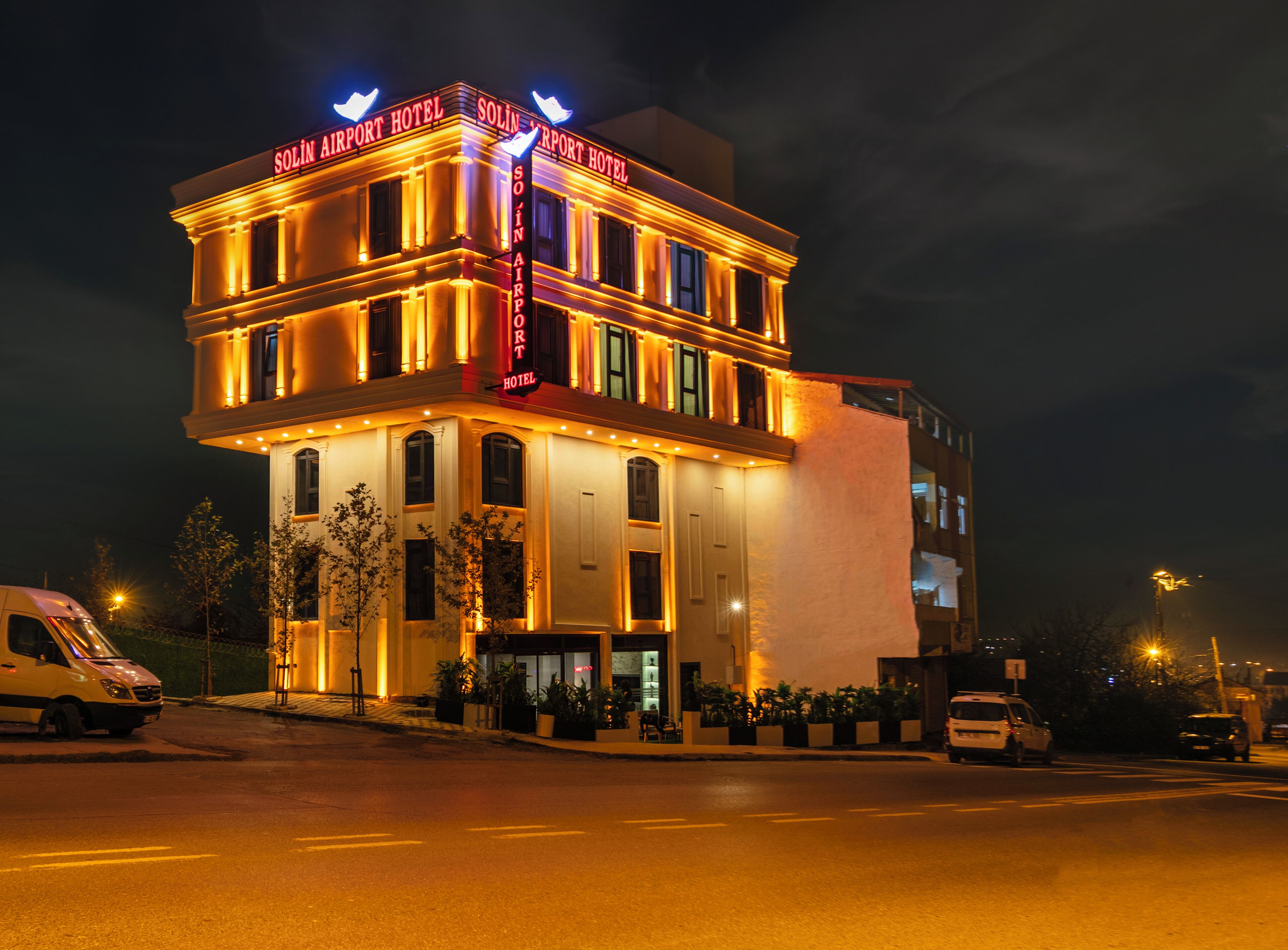 A hotel with a classic architectural style, featuring a prominent sign and a well-lit facade.
