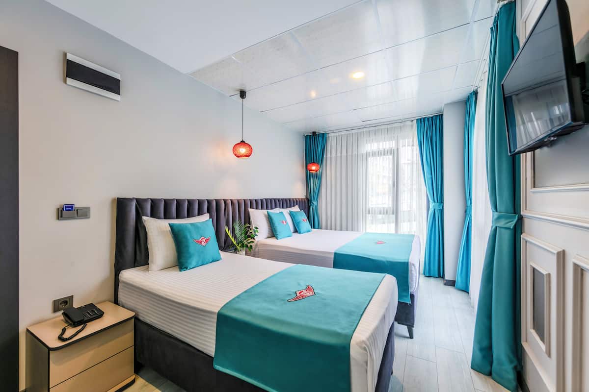 Deluxe Triple Room, City View | In-room safe, desk, laptop workspace, blackout drapes