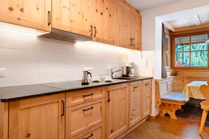 Fridge, stovetop, dishwasher, coffee/tea maker