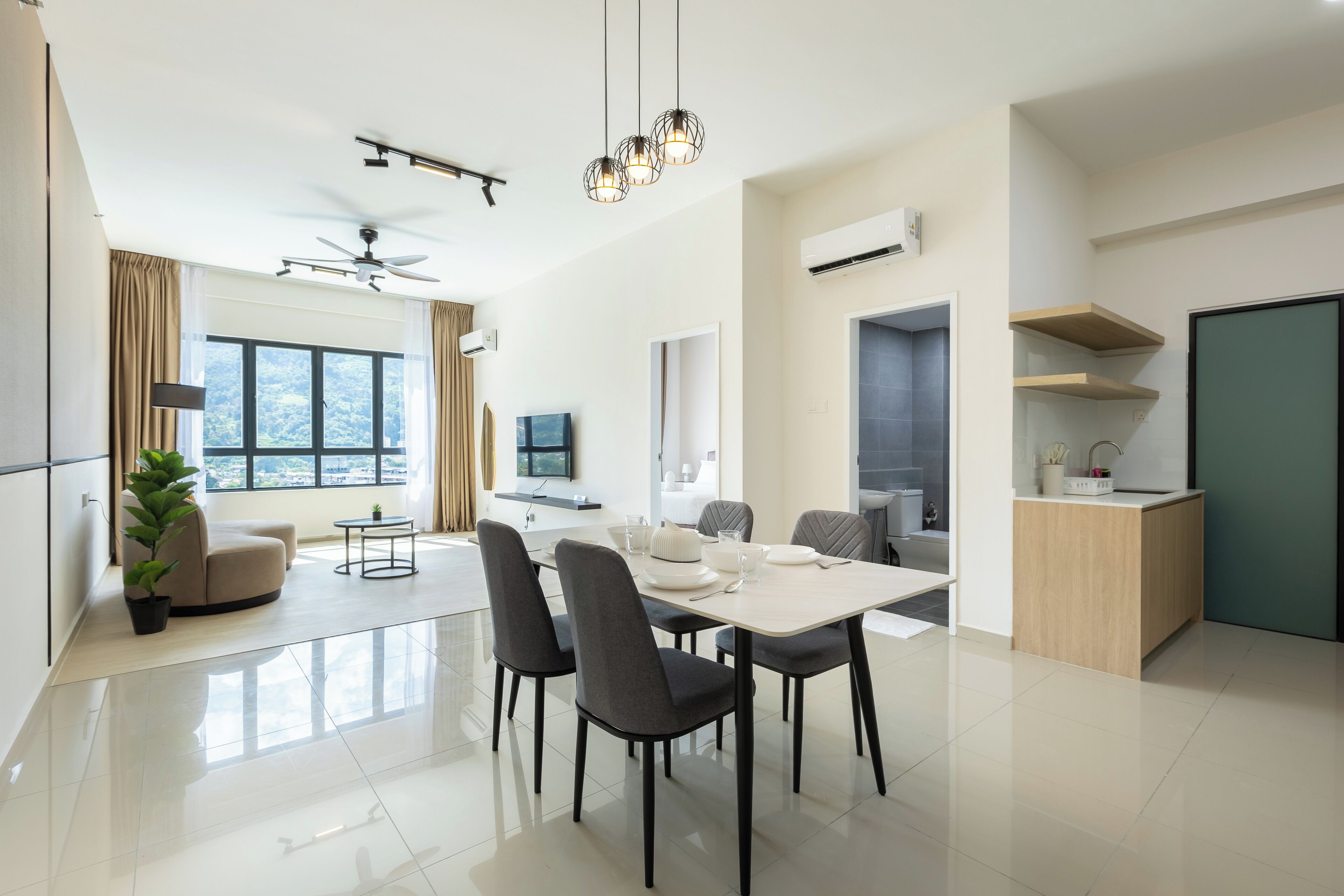 A modern, well-lit dining area with a large table, chairs, and a ceiling fan.