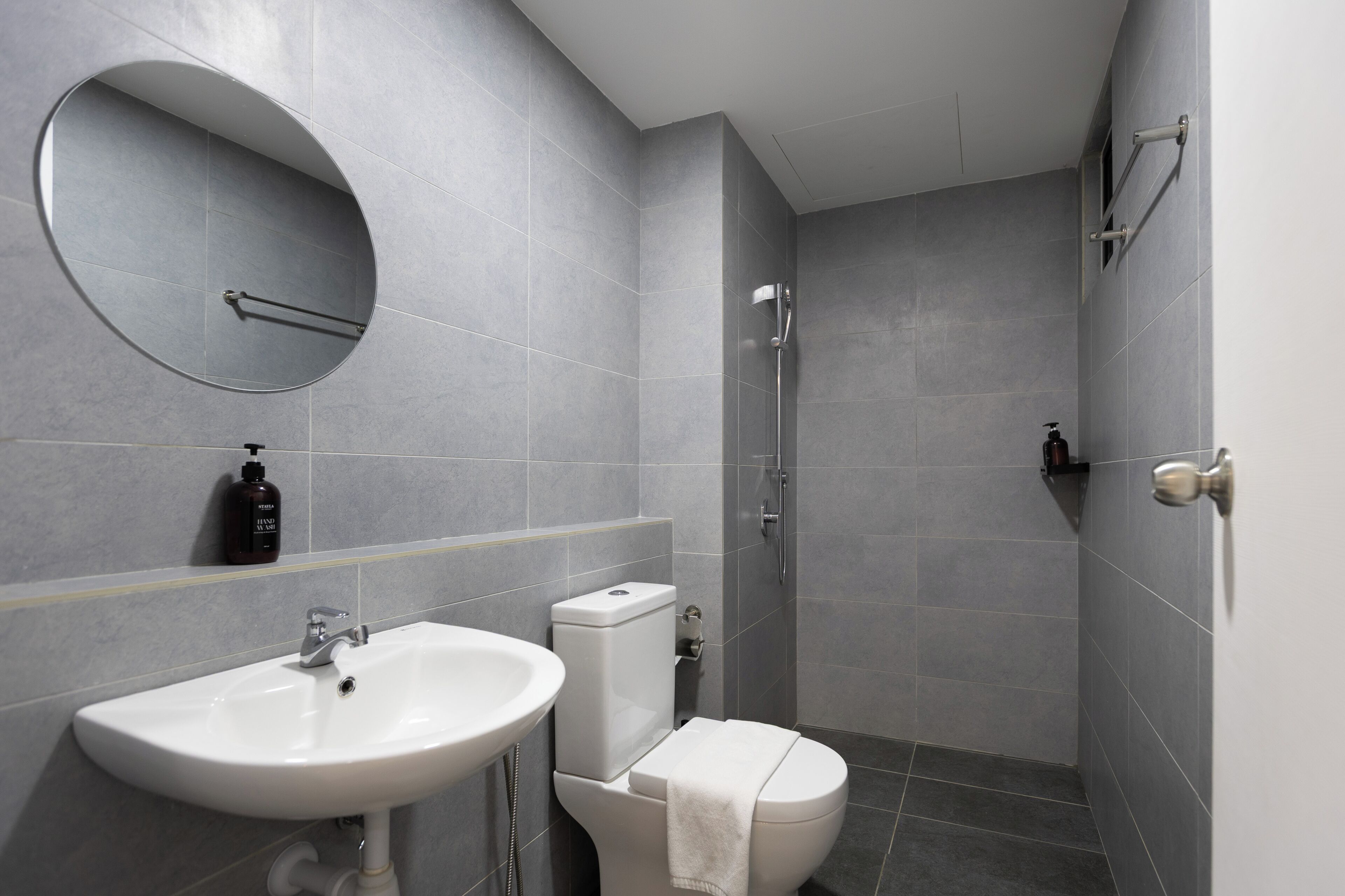 A bathroom with a sink, toilet, and shower.