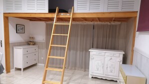 A room with a wooden ladder, white cabinets, and a tiled floor. - Large T2 in villa with sea view and spa not overlooked (La Ciotat)