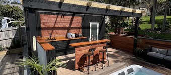 La Maison Soleil - Modern, sun-filled home with 4 bedrooms (2 kings including a stand-alone sleepout in the pool area, 2 queens) and 3 tiled bathrooms. Features a full kitchen, aircon, and open living flowing to a large garden with BBQ, heated swim s