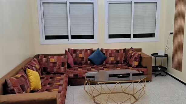 A living room with a sofa set, a coffee table, and a small side table. - Atlas City Center Apartment (Fes)