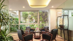 A modern room with large windows, a round table, and four chairs.