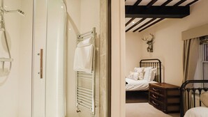 A bathroom with a glass-enclosed shower and a white toilet.