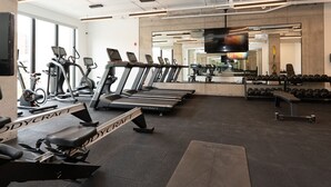 A gym with treadmills, elliptical machines, and a mirrored wall. - *NEW Designer Mid-Century Modern 2B/2B (Halifax)