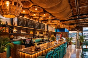 A bar area with a counter, stools, and a menu board listing coffee and tea options. - Venice View Hotel & Restaurant (Udaipur)