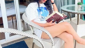 A person sitting on a white wicker chair reading a book. - Skazka Beach Resort (Mandrem)
