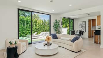 Luxe huis, Meerdere bedden, toegang tot zwembad, uitzicht op zwembad (Casa Leona) | Woonruimte | Een 65-inch flatscreentelevisie met digitale zenders en een open haard