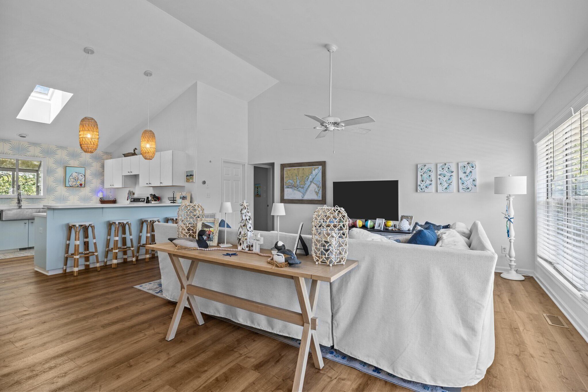 A modern living space with a kitchen, dining area, and seating area.