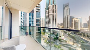 A balcony with a view of a cityscape, including high-rise buildings and a road. - Vibrant 2 Bedroom l Pool with Burj Khalifa View (Downtown Dubai)