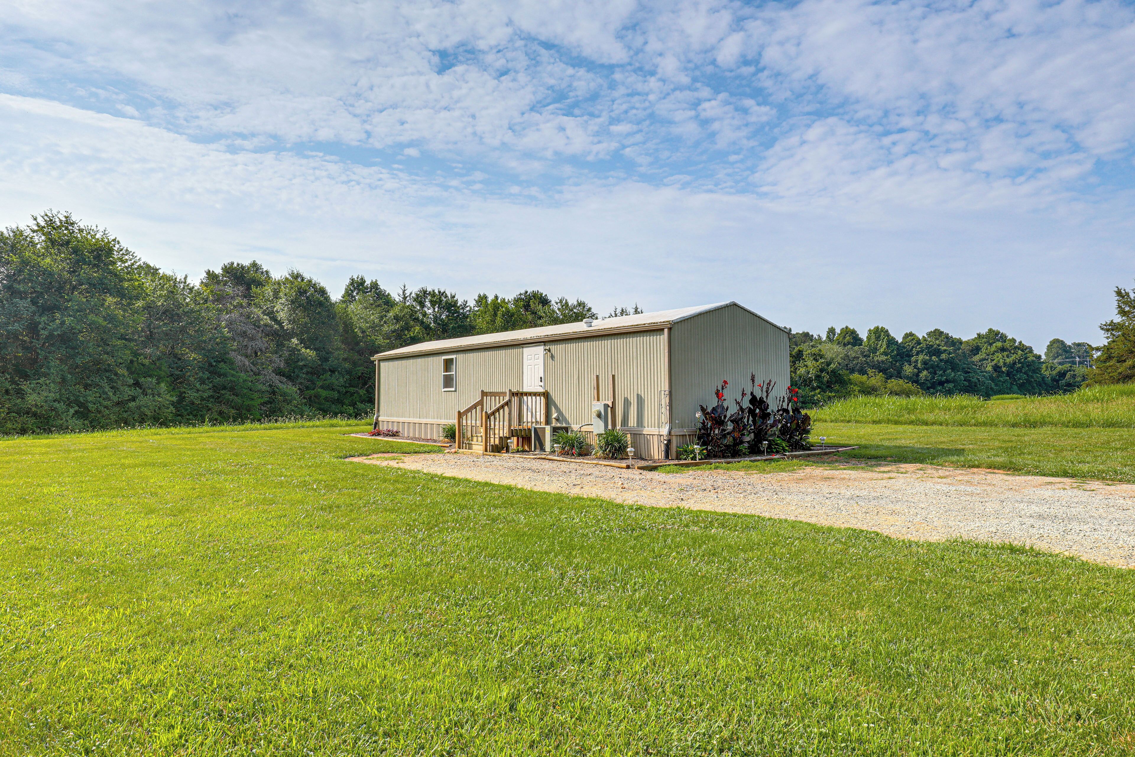 A single-story building with a flat roof, a front porch, and a small attached garage.