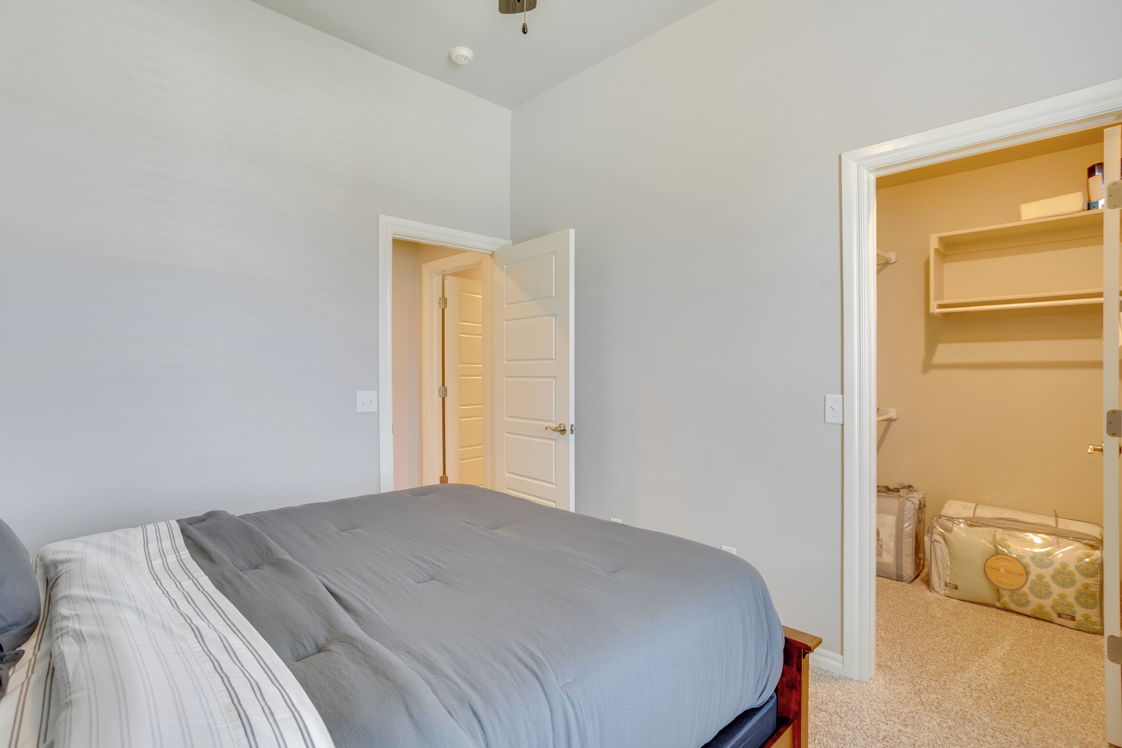 A bedroom with a bed, a wardrobe, and a suitcase.