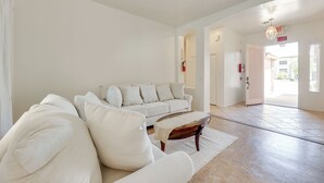 A spacious living room with a white sofa, a coffee table, and a rug. - 3 Mi to Santan Village: Home w/ Covered Patio (Gilbert)