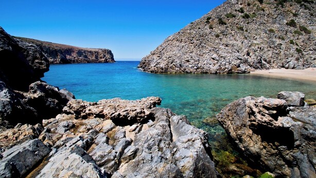 A rocky coastal landscape with clear blue water, rugged terrain, and a distant view of the sea. - Lovely house with breathtaking view (Nebida)
