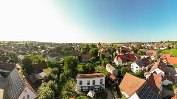 A town with traditional architecture, including houses with sloped roofs and a church with a tower.