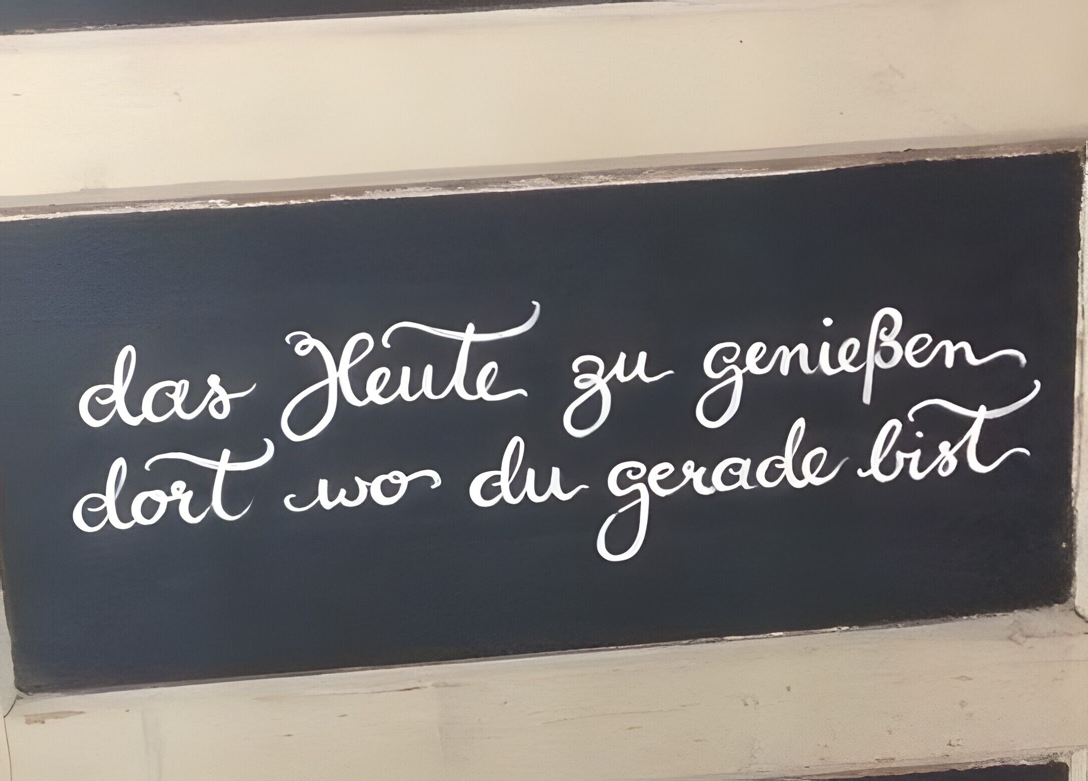 A blackboard with white cursive writing.