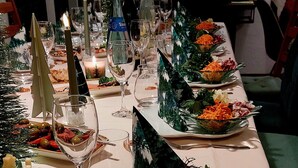 A table set for a meal with plates, glasses, and candles. - Room 'No. 4' with Shared Terrace, Communal Garden and Wi-Fi (Bad Urach)