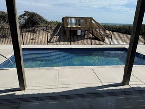 A swimming pool with a wooden deck and a lifeguard stand. - Salty Haven - Endless Views - Beachfront & Pool - 7BR (Indian Beach)