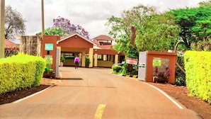 A building with a sign indicating no motorbikes allowed. - Theta Country Resort (Juja)