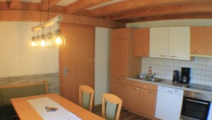 A kitchen with wooden cabinets, a dishwasher, and a coffee maker.