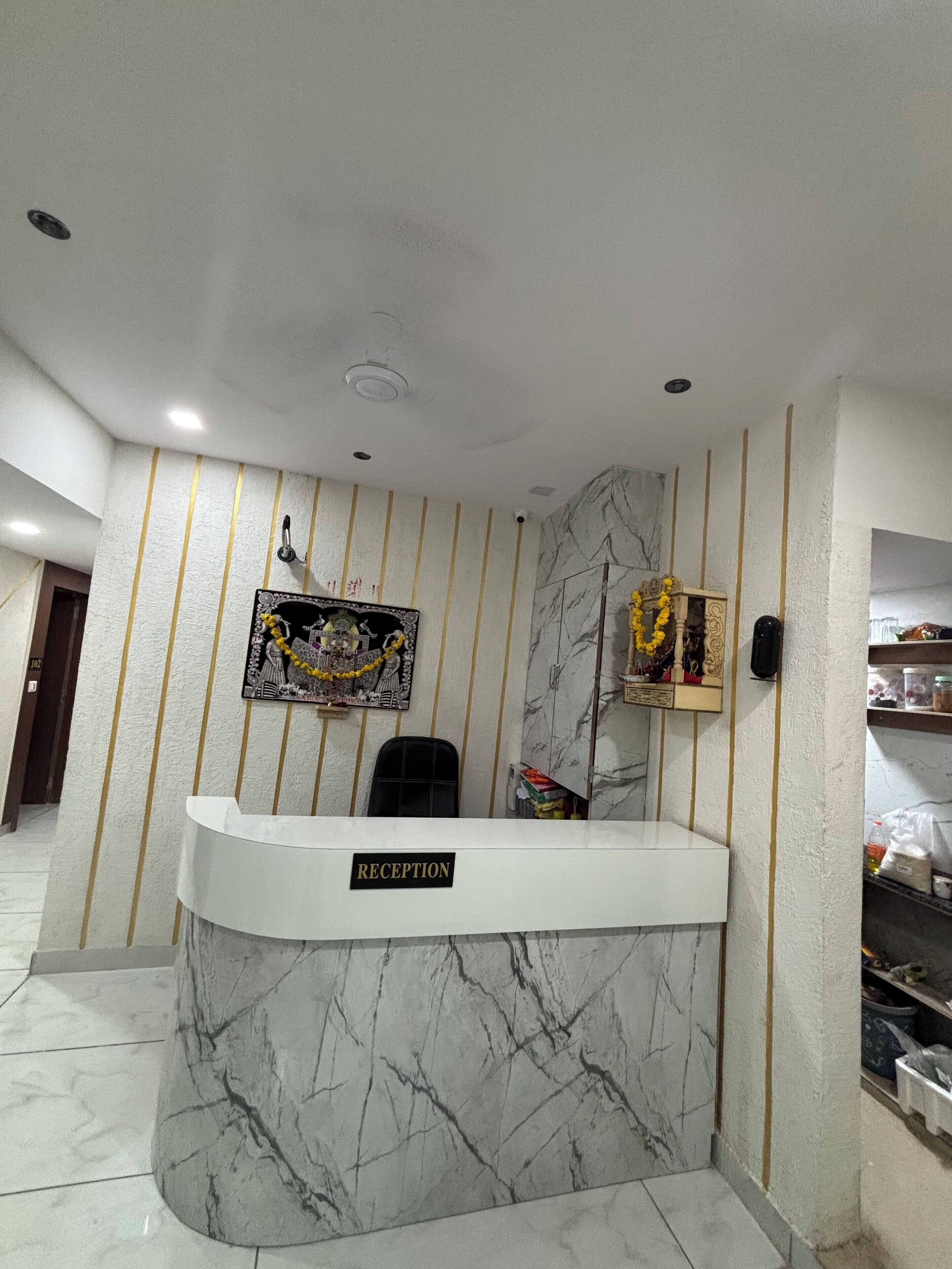 A reception desk with a marble base and a sign that reads "RECEPTION".