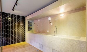A modern bathroom with a tiled wall, a wooden floor, and a shower area. - Building w/ Pool and Gym in Paraiso - ONP (São Paulo)